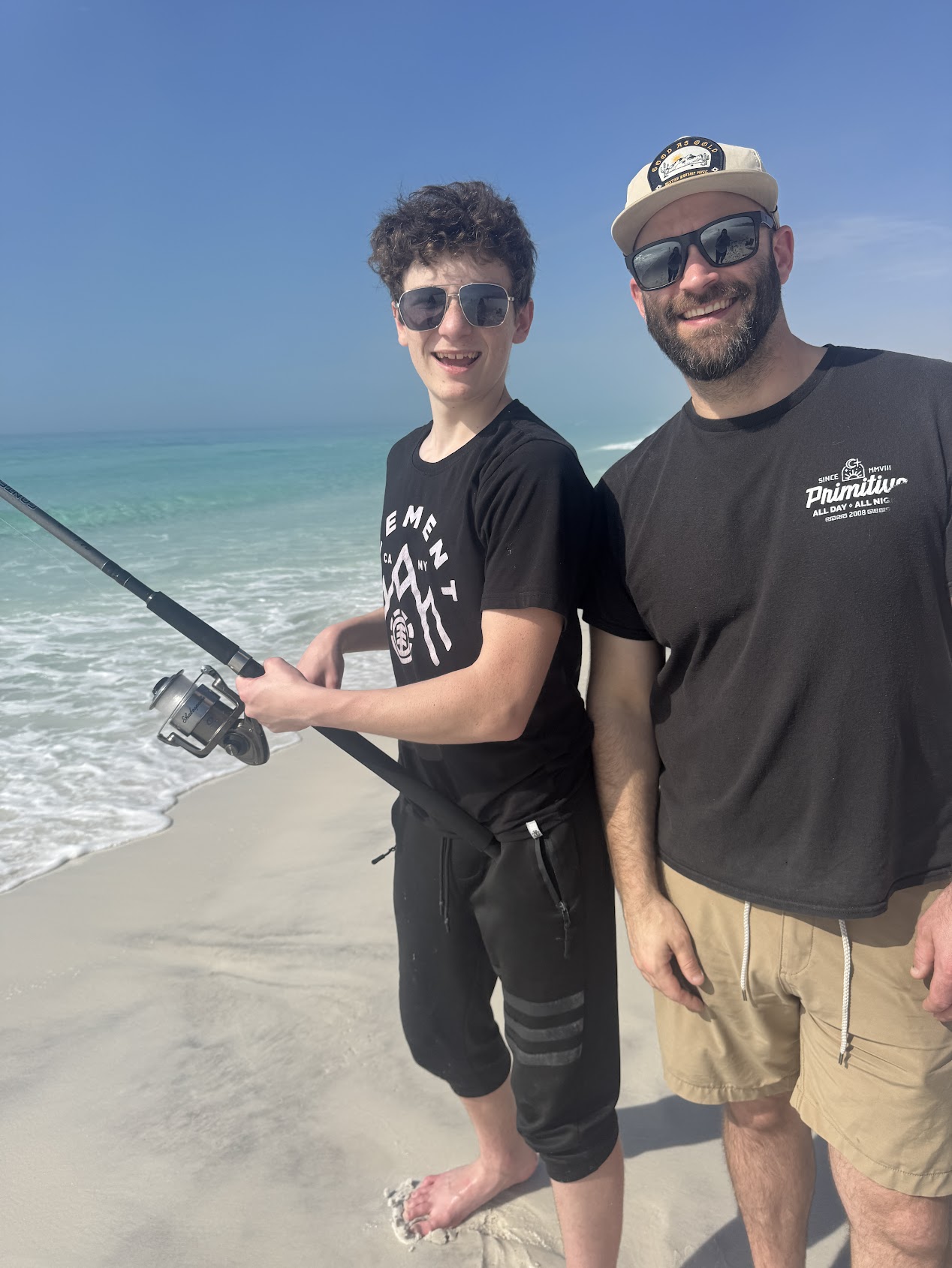 Jordan with his son fishing on the beach